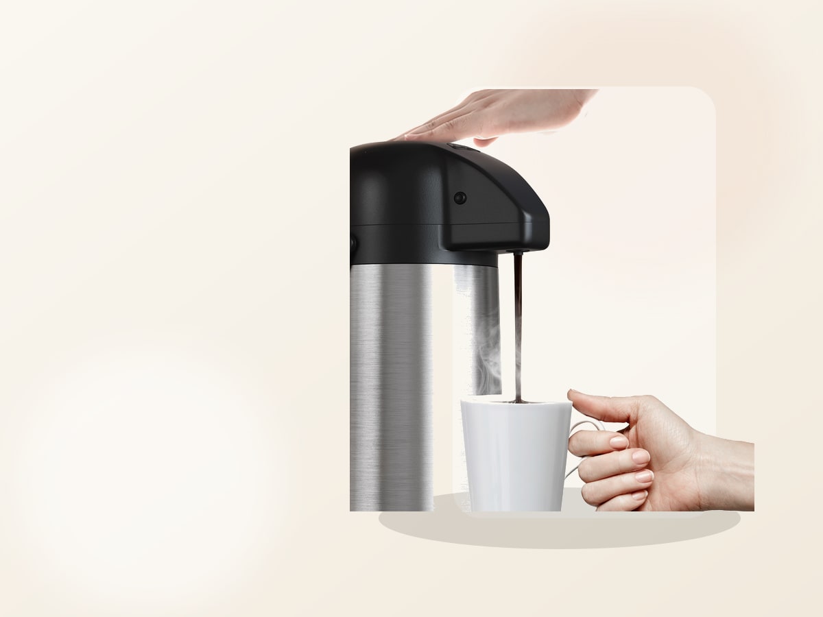 Gezoss 102 oz Stainless Airpot on a warm kitchen counter with coffee cups and morning light