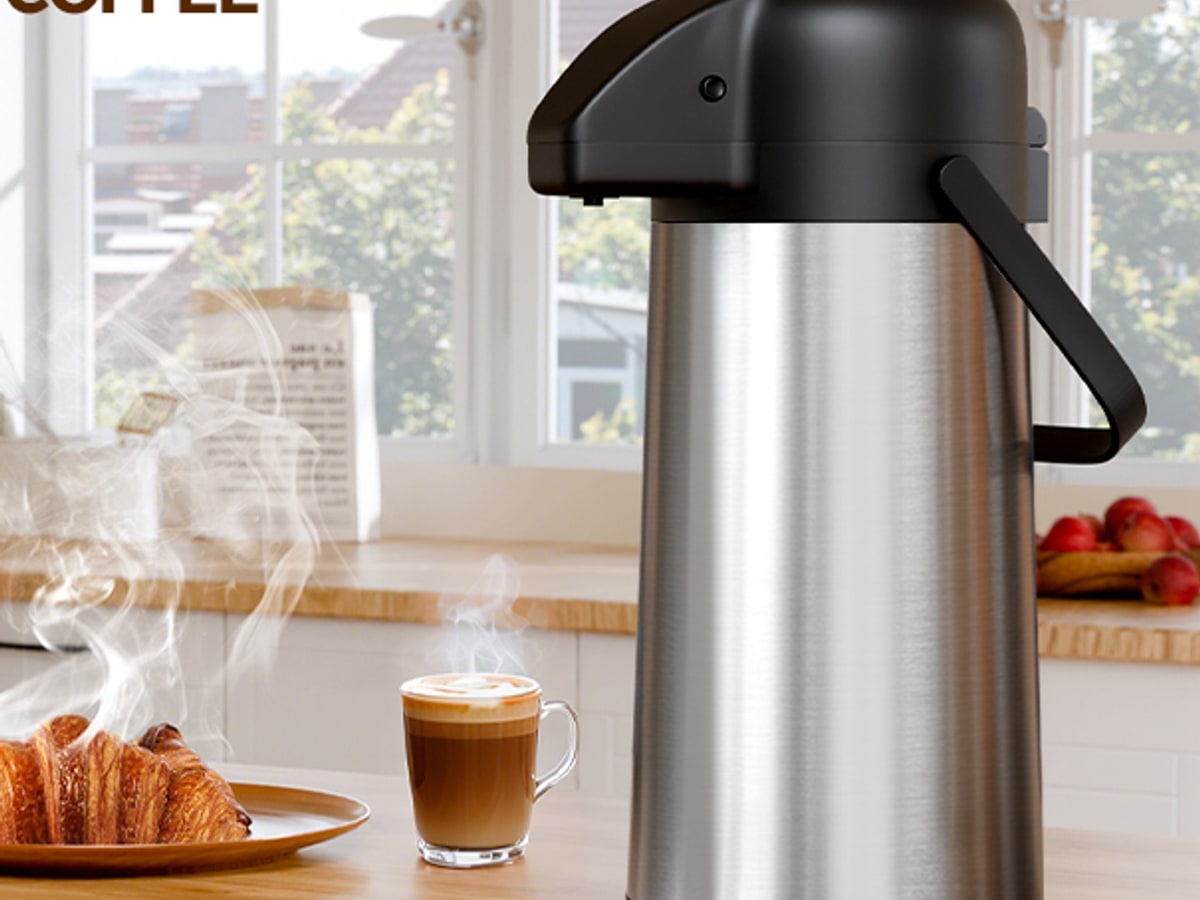 Gezoss 102 oz Stainless Airpot on a warm kitchen counter with coffee cups and morning light